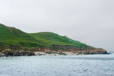 rocky overgrown coastal scenery at the Seven Islands in Brittany, Franceの写真素材