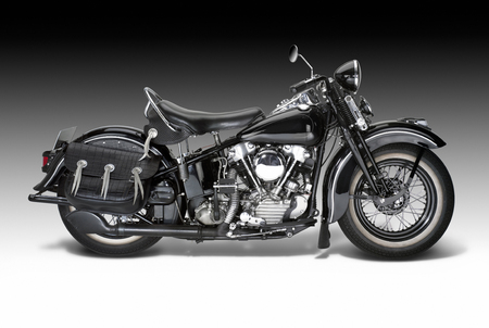 sideways shot of a vintage motorbike in gradient backの写真素材