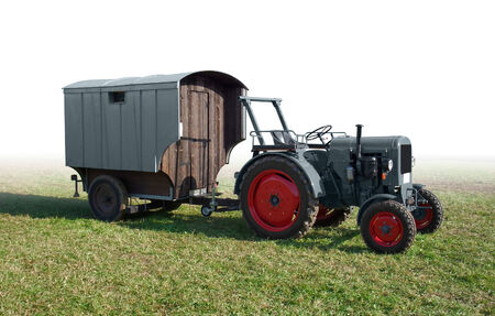 historic traction engine with rundown trailer on a meadow, gradient isolatedの写真素材