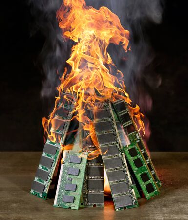 burning pile of random access memory sticks in front of dark back