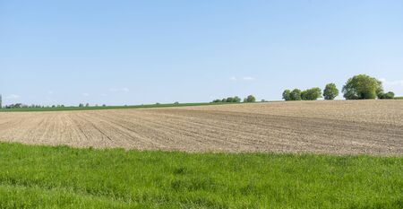 sunny agricultural scenery at a plowed field in Hohenlohe, a district in Southern Germany