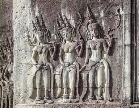 stone-carved figures at a temple complex named Angkor Wat in Cambodia