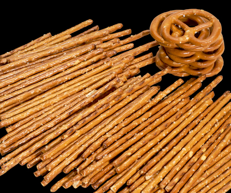 closeup of some salt sticks and pretzels in dark backの写真素材