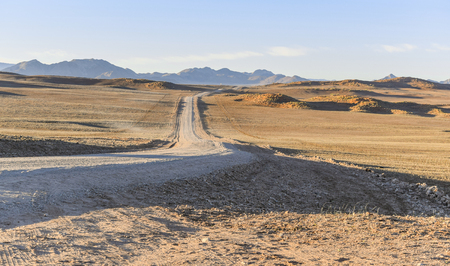 abandoned area with dirt road at evening time in Namibia, Africaの写真素材