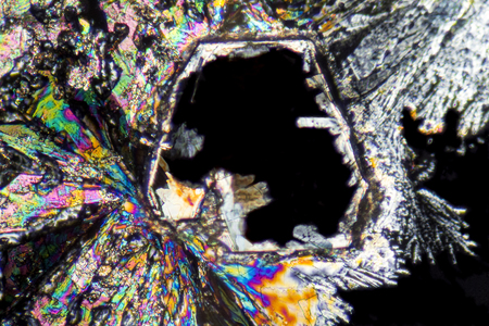 macro shot of growing microcrystals of soda lye in polarized lightの写真素材
