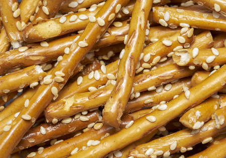 full frame closeup of some baked sesame sticksの写真素材