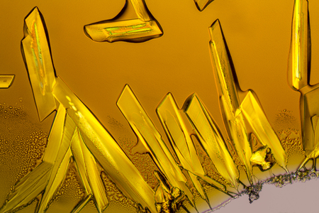 microscopic shot if some Iron (III) chloride microcrystals in fluid ambianceの写真素材