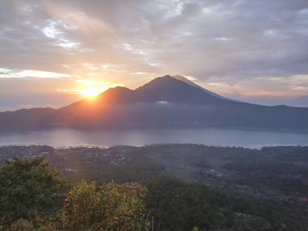 cloudy evening scenery around a volcano named Mount Batur in Bali, Indonesiaの写真素材
