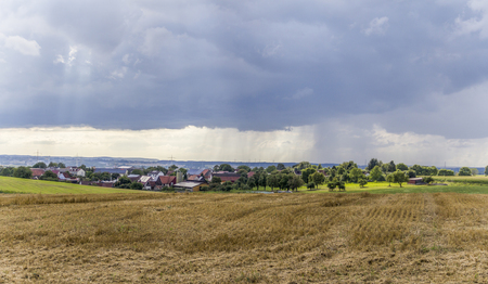rainy scenery including a small village in rural agricultural ambianceの写真素材