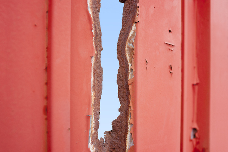 weathered rusty paint-coated perforated backgroundの写真素材