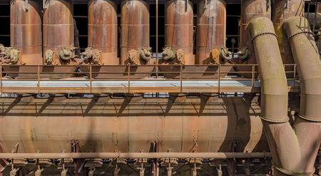 weathered rusty high angle industrial scenery with old corroded steel girders and metal tubesの写真素材