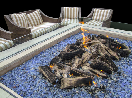 artificial fireplace and chairs in dark ambianceの写真素材