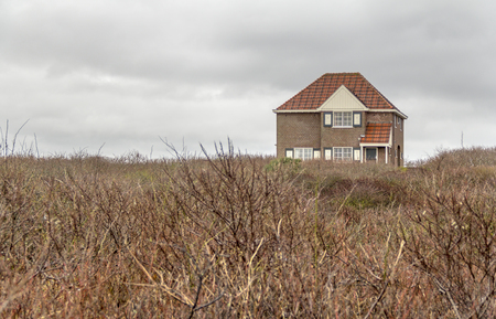 overgrown coastal scenery including a abandoned house at the North Sea in Walcheren in the dutch province of Zeelandの写真素材