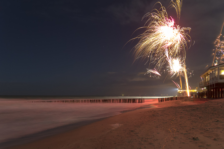 coastal scenery at night including some fireworks at the beach near Domburg in Zeelandの写真素材