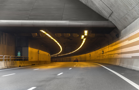 illuminated highway tunnel and roadの写真素材