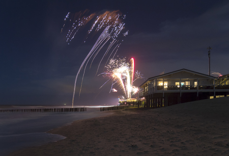 coastal scenery at night including some fireworks at the beach near Domburg in Zeelandの写真素材
