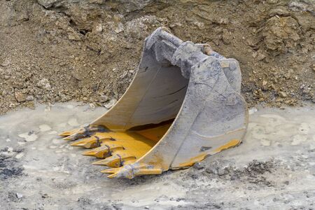 old dredger bucket on loamy ground