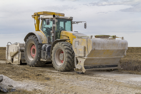 yellow loader at a loamy construction siteの写真素材
