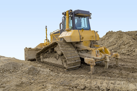 yellow bulldozer at a loamy construction siteの写真素材