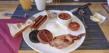 Traditional irish breakfast with bacon, sausage, beans and other ingredients