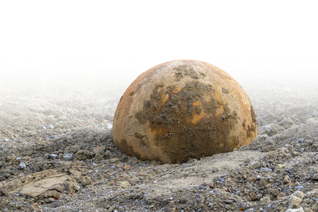 Big rusty metal ball in gradient gravel backの写真素材