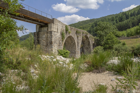 Historic stone bridge at the Ardeche river in southern Franceの写真素材