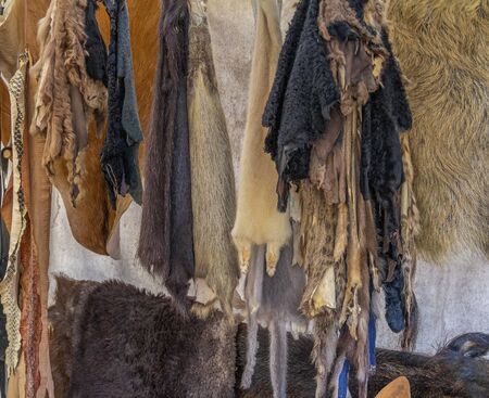various hanging fur and leather pieces seen at a medieval marketの写真素材