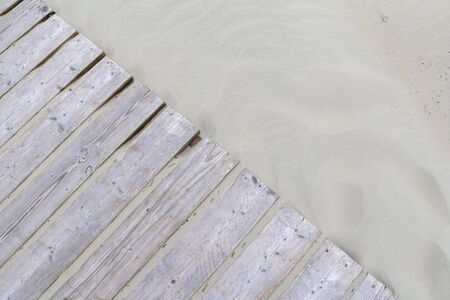 wooden planks on sandy ground seen from aboveの写真素材