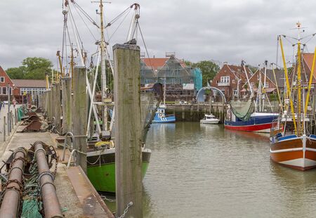 Fishing village named Neuharlingersiel located in East Frisia, Germanyの写真素材