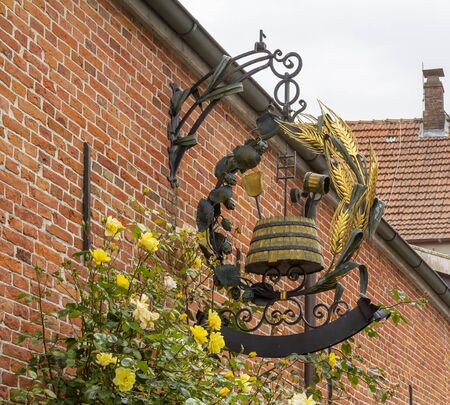 historic signboard in a city named Jever which is located in East Frisia in Northern Germanyの写真素材
