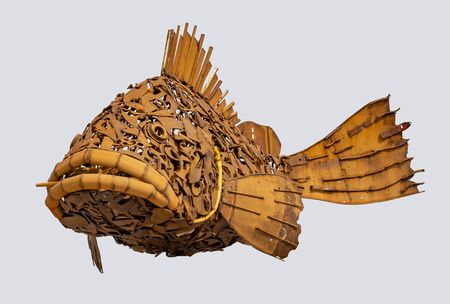 rusty fish sculpture isolated in light back