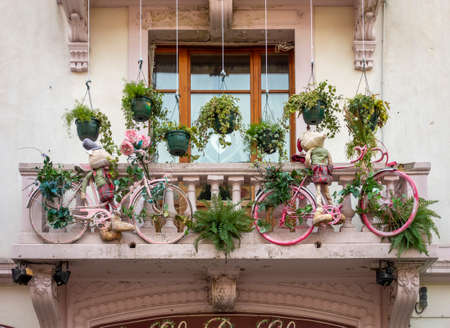 two pink bicycles hanging at a balcony seen in Franceの写真素材