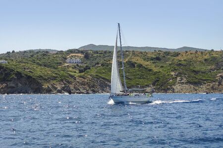 coastal scenery with sailing boat at Skiathos which is one of the greek Sporades islands