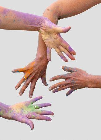 female hands covered with colorful paint splatters in light gray back