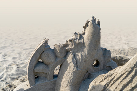Detail shot of a disintegrating sculpture made of sand seen at a beach in Italyの写真素材