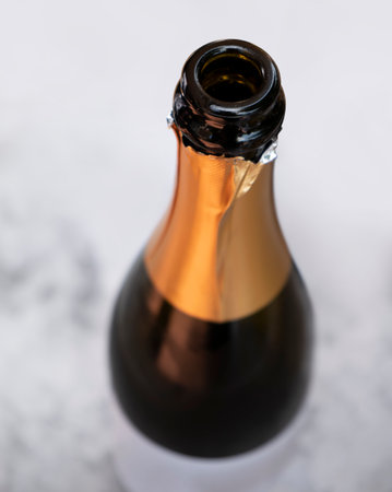 Open champagne bottle seen from above in light ambianceの写真素材