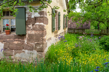 Historic house with garden at a rural village in Hohenlohe, an area in Southern Germany at spring timeの写真素材