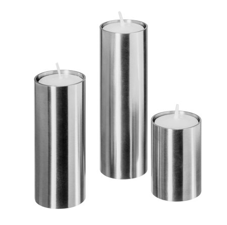 Three clean and simple candle holders made of reflective metal isolated in white backの写真素材