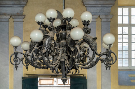 Historic dusty chandelier seen at the University of Genoa, the capital of the Italian region of Liguriaの写真素材