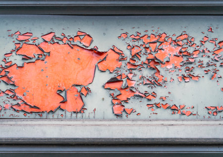Closeup shot of some flaking paint on red groundの写真素材