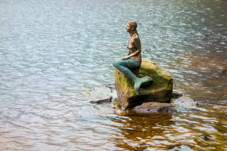 Mermaid sculpture at the Mummelsee, a small lake at the western mountainside of the Hornisgrinde in the Northern Black Forest of Germanyの写真素材