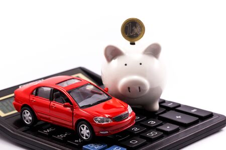 piggy bank and euro with red carの写真素材