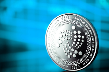 iota coin cryptocurrency on the blue backgroundの写真素材