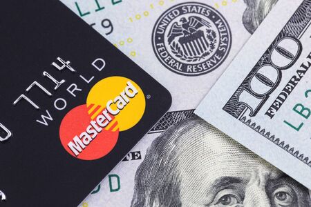 MasterCard and one hundred dollars banknotes. Ekaterinburg, Russia - April 11, 2018のeditorial素材