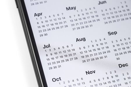 smartphone with calendar on the screen on the white background. Moscow, Russia - October 26, 2018のeditorial素材