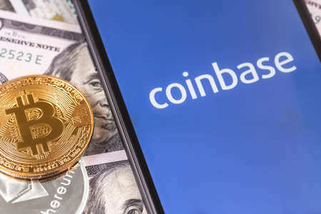 dollars, bitcoin, ethereum and smartphone with Coinbase logo on the screen. Coinbase is a digital...