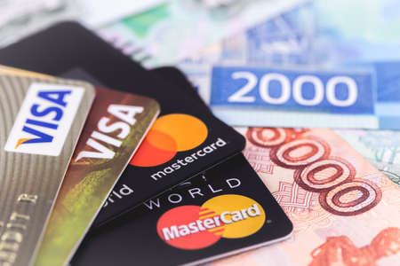 MasterCard and Visa with russian rubles banknotes. Visa and MasterCard worldwide is an American multinational financial services corporation. Moscow, Russia - January 24, 2019のeditorial素材