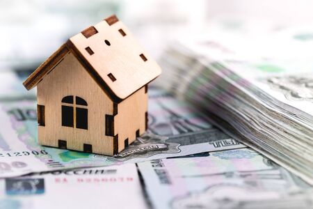 wooden house symbol and russian rubles banknotesの写真素材