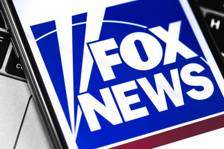 closeup notebook and smartphone with FoxNews logo on the screen. Fox News is an American basic cable and satellite television news channel. Moscow, Russia - March 26, 2019のeditorial素材