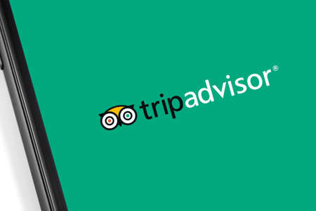 smartphone with Tripadvisor logo on the screen. Tripadvisor is a travel site for customer reviews and rating. Moscow, Russia - March 17, 2019のeditorial素材